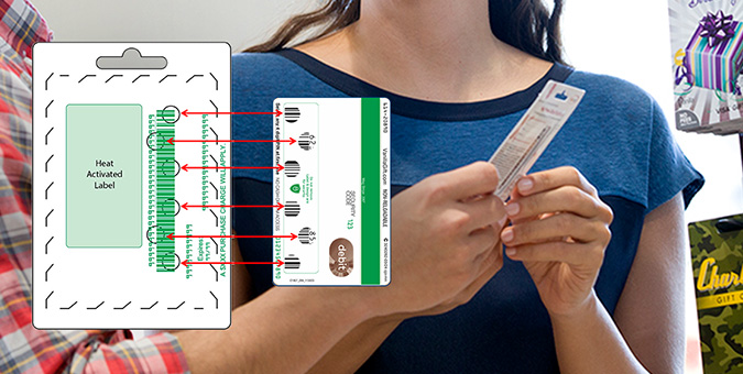 Demonstration of a heat-activated label with a card; a person holds the card while a diagram shows activation arrows from the label to the card